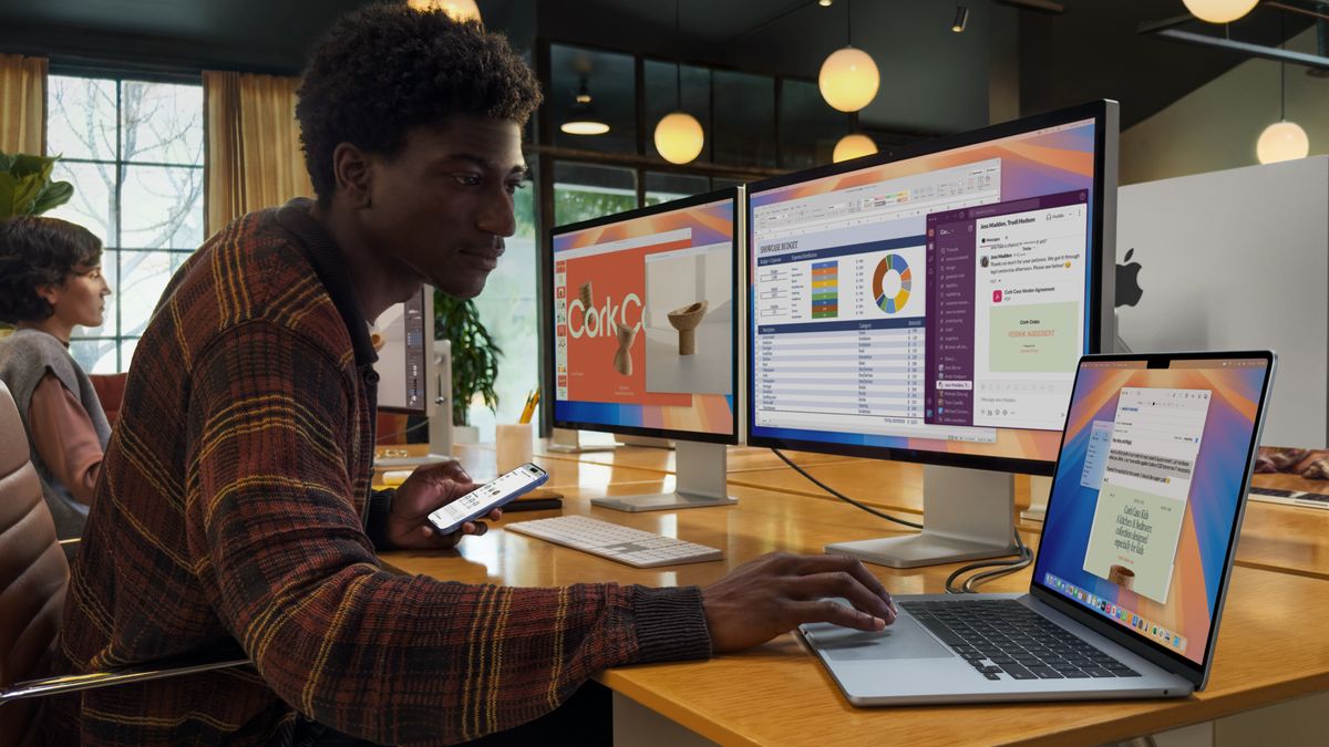 A man using a MacBook Air M4 at a desk with two monitors
