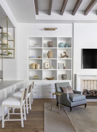 Small white room with open shelving by Marie Flanigan Interiors