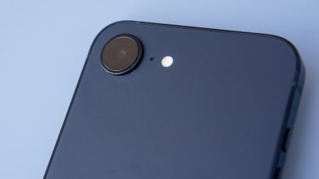 iPhone 16e in black on blue background