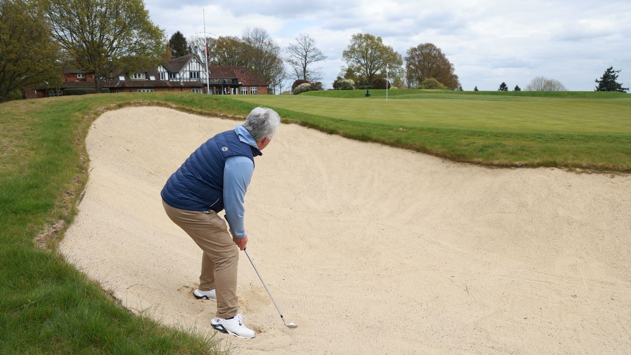 Golfer playing a bunker shot