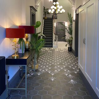 luxury hallway with sparkling floor tiles and mirrored furniture