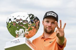 Rasmus Neergaard-Petersen holds up three fingers after winning