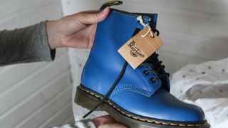 A person examines blue doc martens