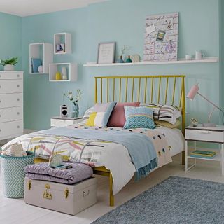 childrens room with blue walls and white furniture