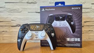 The Last of Us Limited Edition DualSense on a wooden surface in front of a white brick background