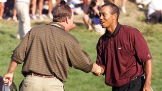 Tiger Woods (R) of the US shakes hands with fellow countryman Bob May (L) after their final putts on the 18th hole 20 August 2000 to force a playoff in the 82nd PGA Championship at Valhalla Golf Club