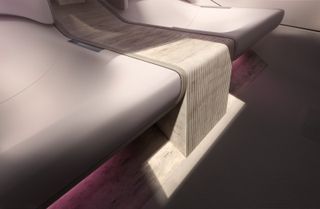 A waterfall of travertine forms the centre console and seat support