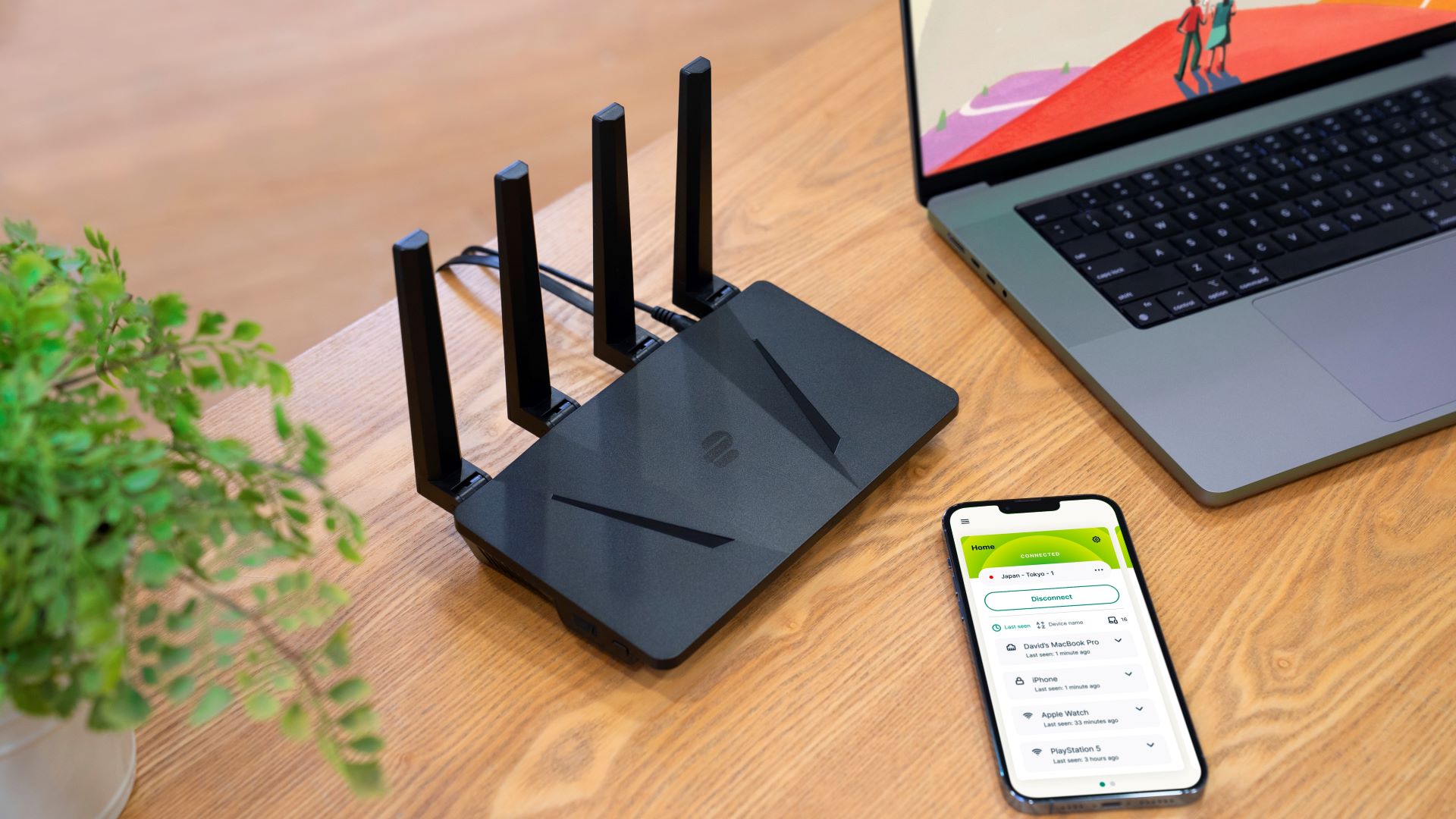 Aircove router, smartphone and laptop with ExpressVPN app on screen on a wooden table 