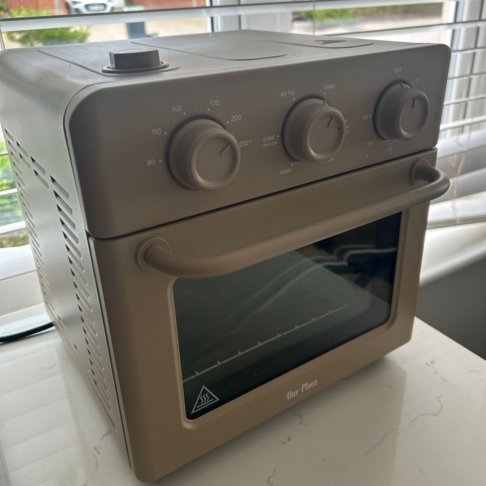 Our Place Wonder Oven in beige on kitchen counter