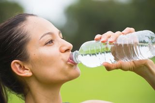 Woman drinking a bottle of water.