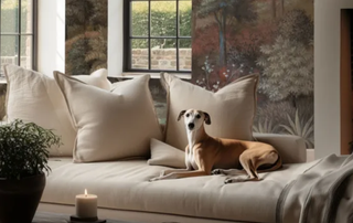 living room with wall mural and large cream sofa with dog