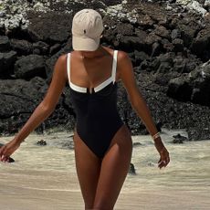 Jasmine Tookes styles a black and white swimsuit.
