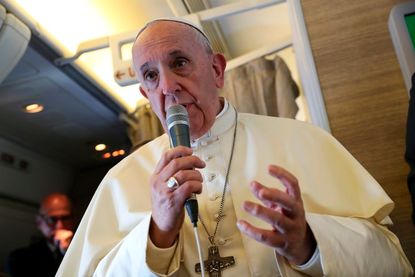 Pope Francis speaks to reporters aboard a plane on the way to Abu Dhabi on February 3, 2019.