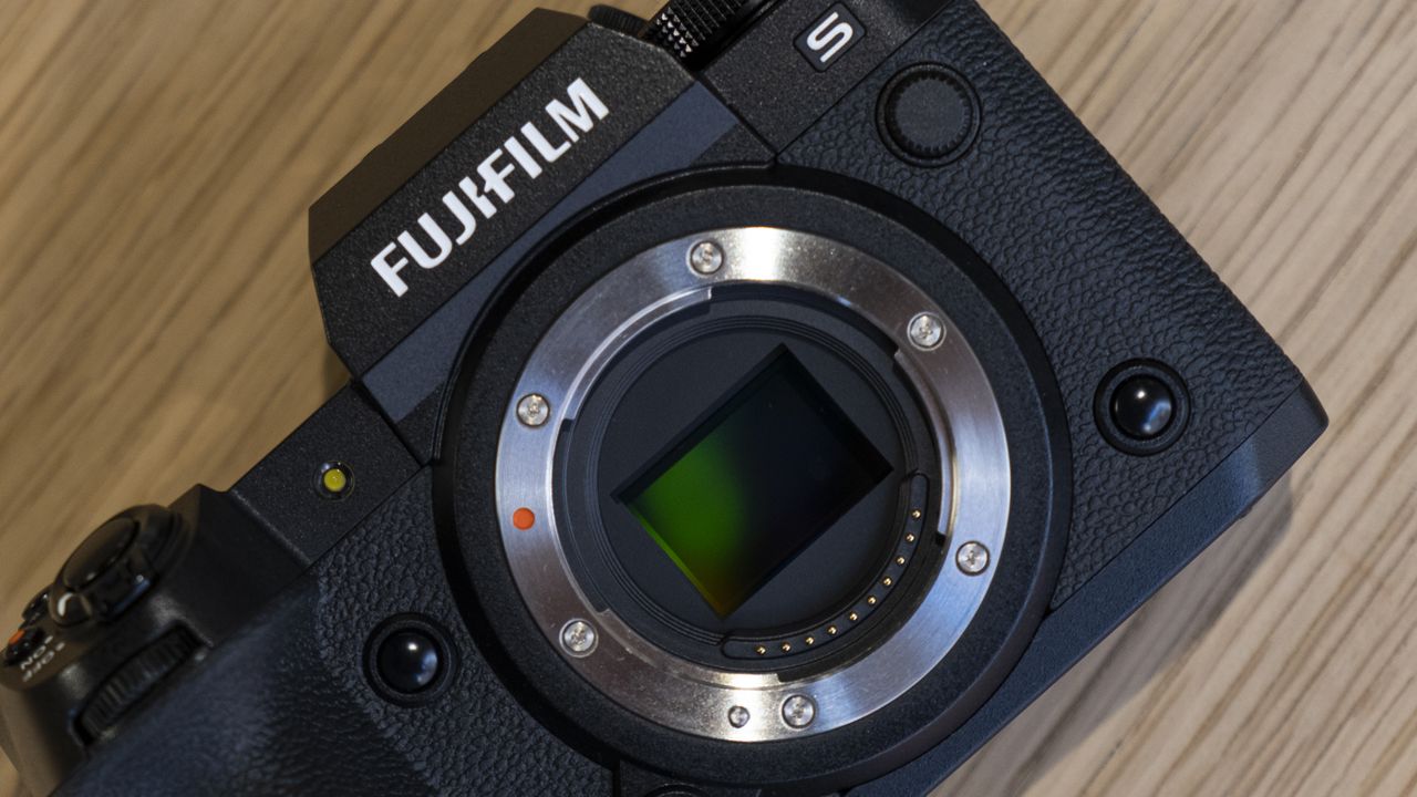 The Fujifilm X-H2S camera on a wooden table