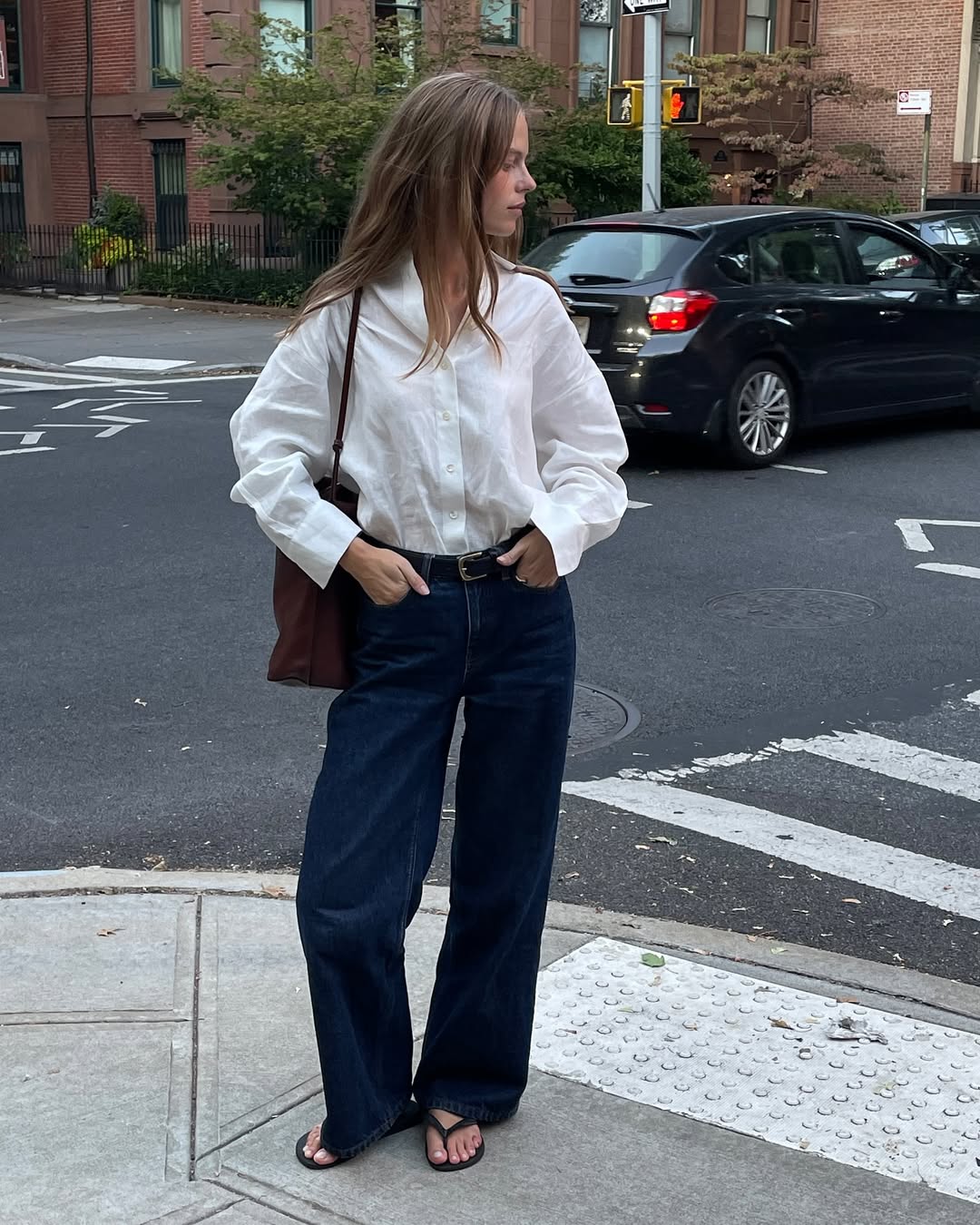 Clara in white shirt and dark wash jeans