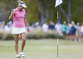 Lexi Thompson collects her ball from the hole after making an ace at the 2023 Grant Thornton Invitational