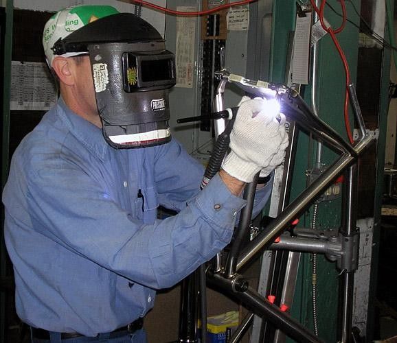 Tim Delaney works at one of a half-dozen welding bays in the Seven factory floor.