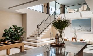 Interior with granite counter and pool table, staircase leading to mezzanine at Sabina Estates Villa