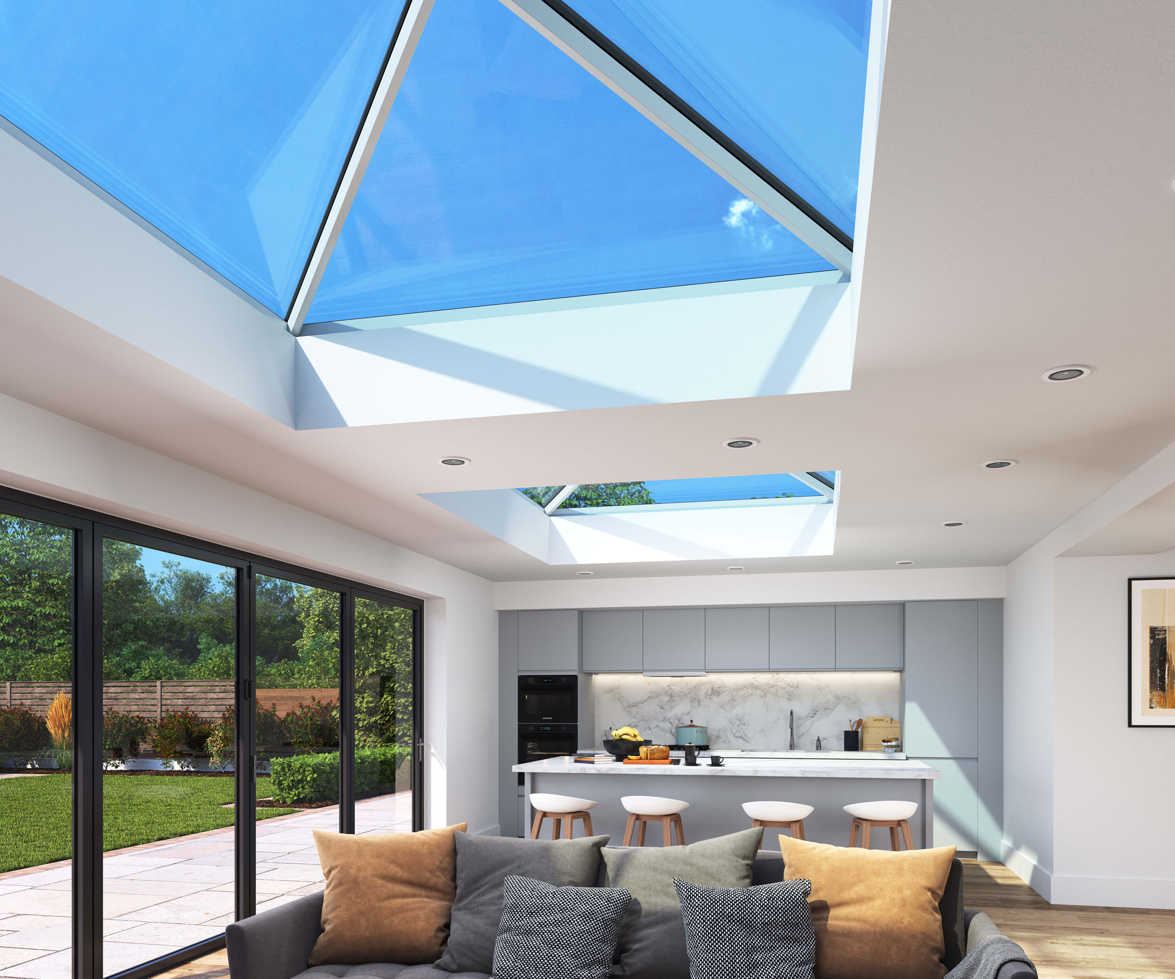 Double roof lanterns letting in natural light into a contemporary kitchen diner with bi-fold doors