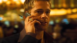 Brad Pitt holding a cell phone up to his ear in Ocean's Eleven.