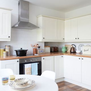 kitchen with white cabinets and wooden worktop