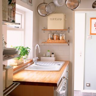 kitchen with wooden worktop and shelf