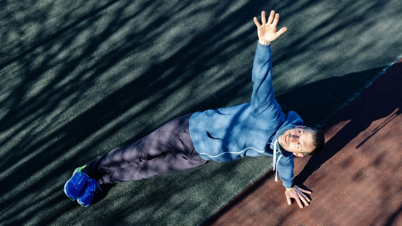 A man performing a push-up with rotation