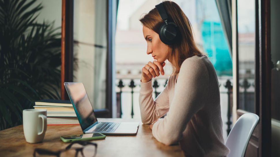 A person using a laptop at home.