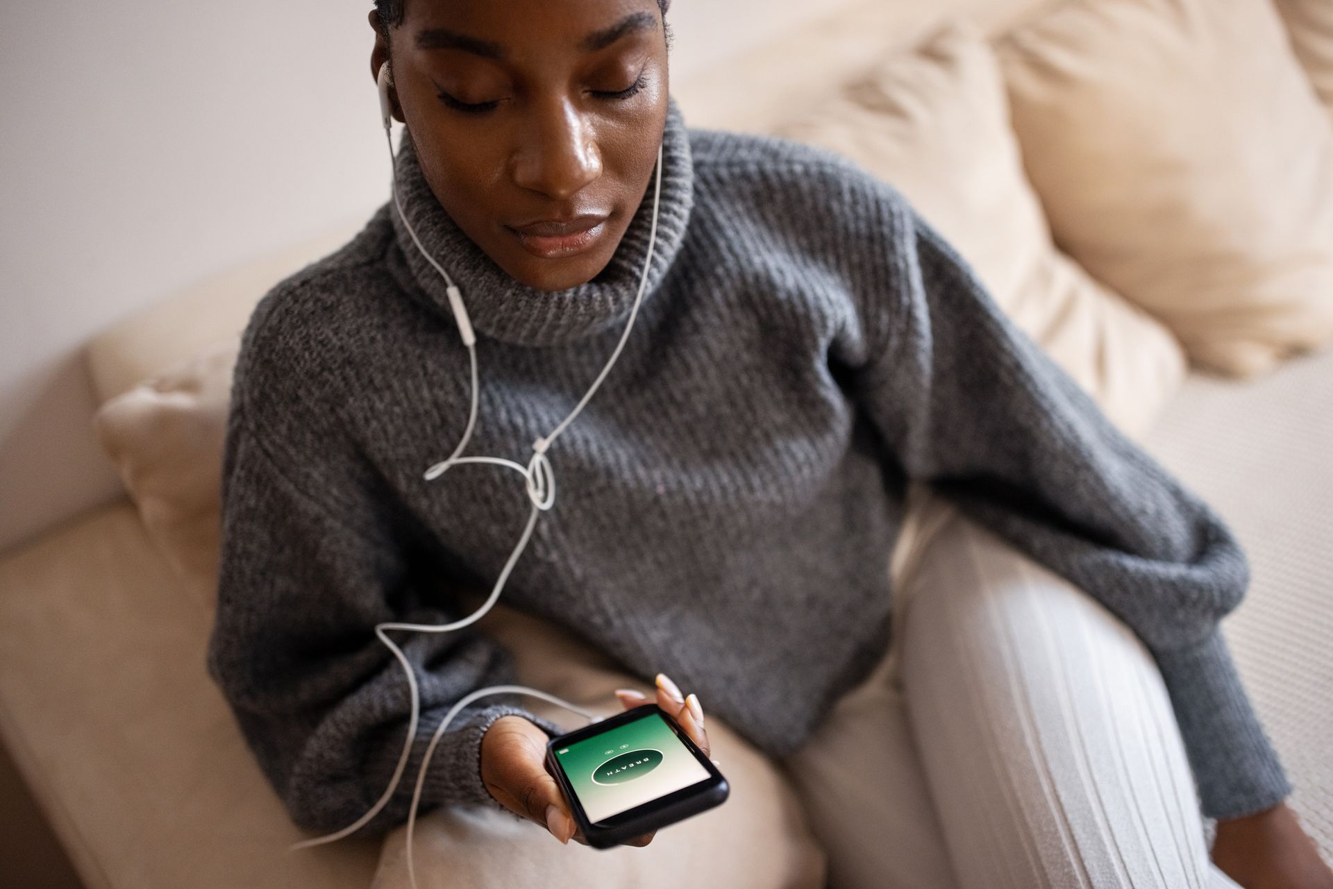 A woman on her phone using a stress app