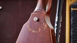 The semi-circular ‘buckle rash’ on this guitar was likely created by the buckle of a guitar strap