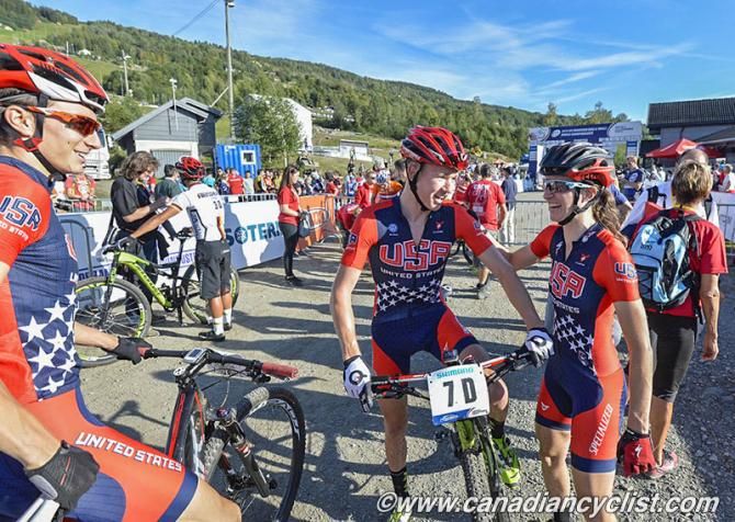US team riders congratulate each other after finishing fourth in the team relay