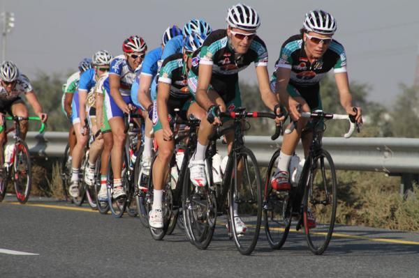 Three teammates work to chase the leaders