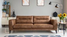 grey living room with brown leather with a need to know how to clean a leather sofa to keep it looking its best