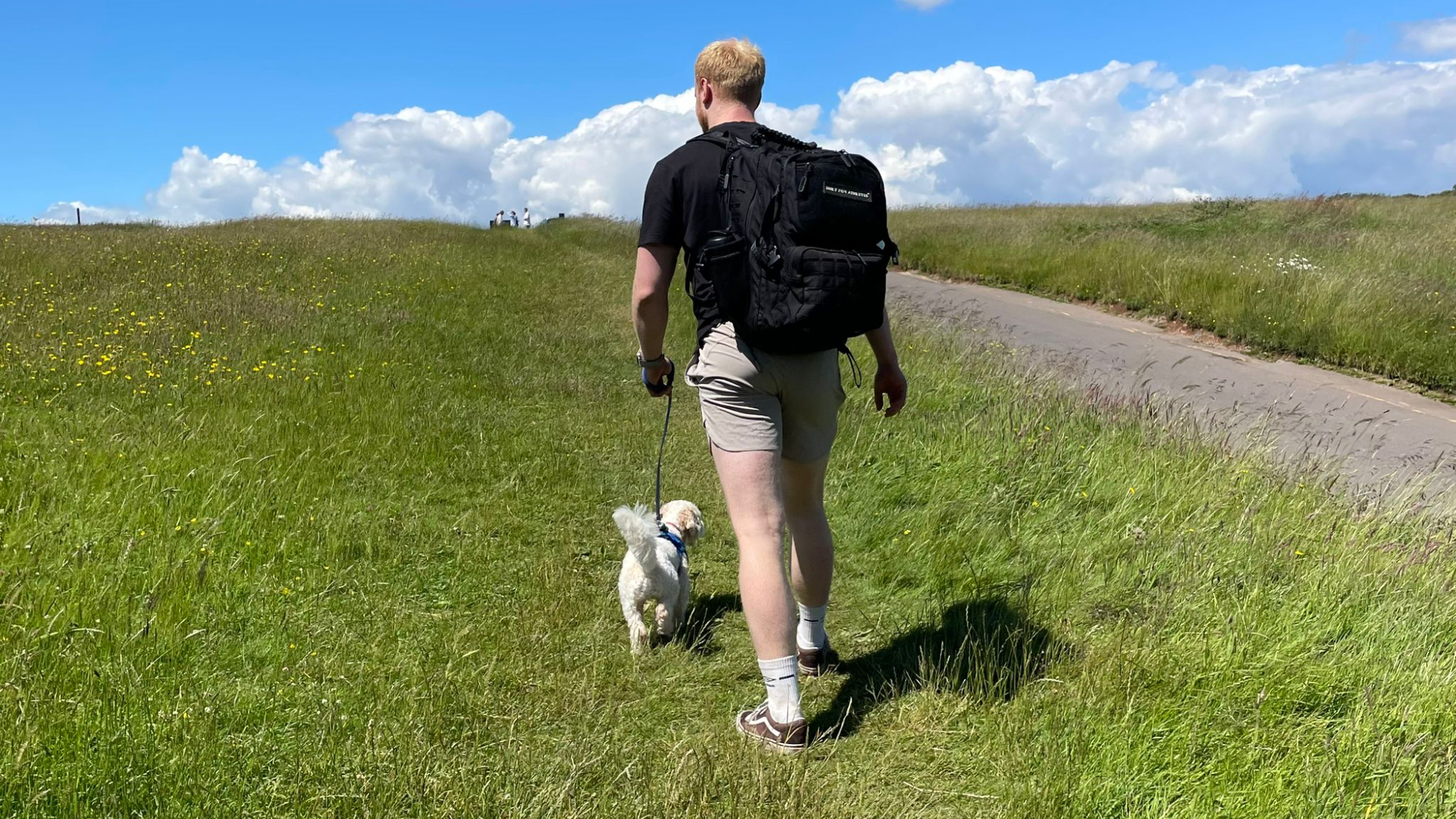 TechRadar fitness writer Harry Bullmore walking his dog in a park