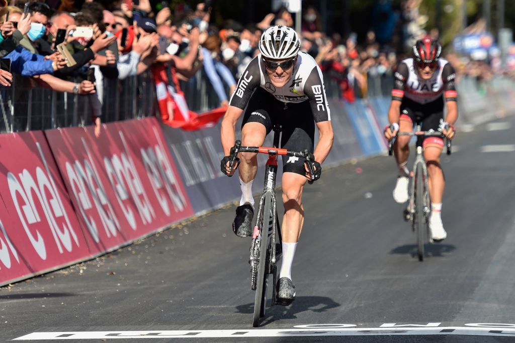 Team Qhubeka Assos rider Switzerlands Mauro Schmid C followed by Team UAE Emirates rider Italys Alessandro Covi rides to cross the finish line to win the eleventh stage of the Giro dItalia 2021 cycling race 162 km between Perugia and Montalcino on May 19 2021 Photo by Tommaso Pelagalli AFP Photo by TOMMASO PELAGALLIAFP via Getty Images