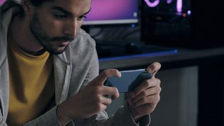 Sony Xperia 5 II Android phone being used by a man to play mobile games