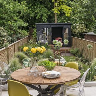 backyard garden with round table and plants