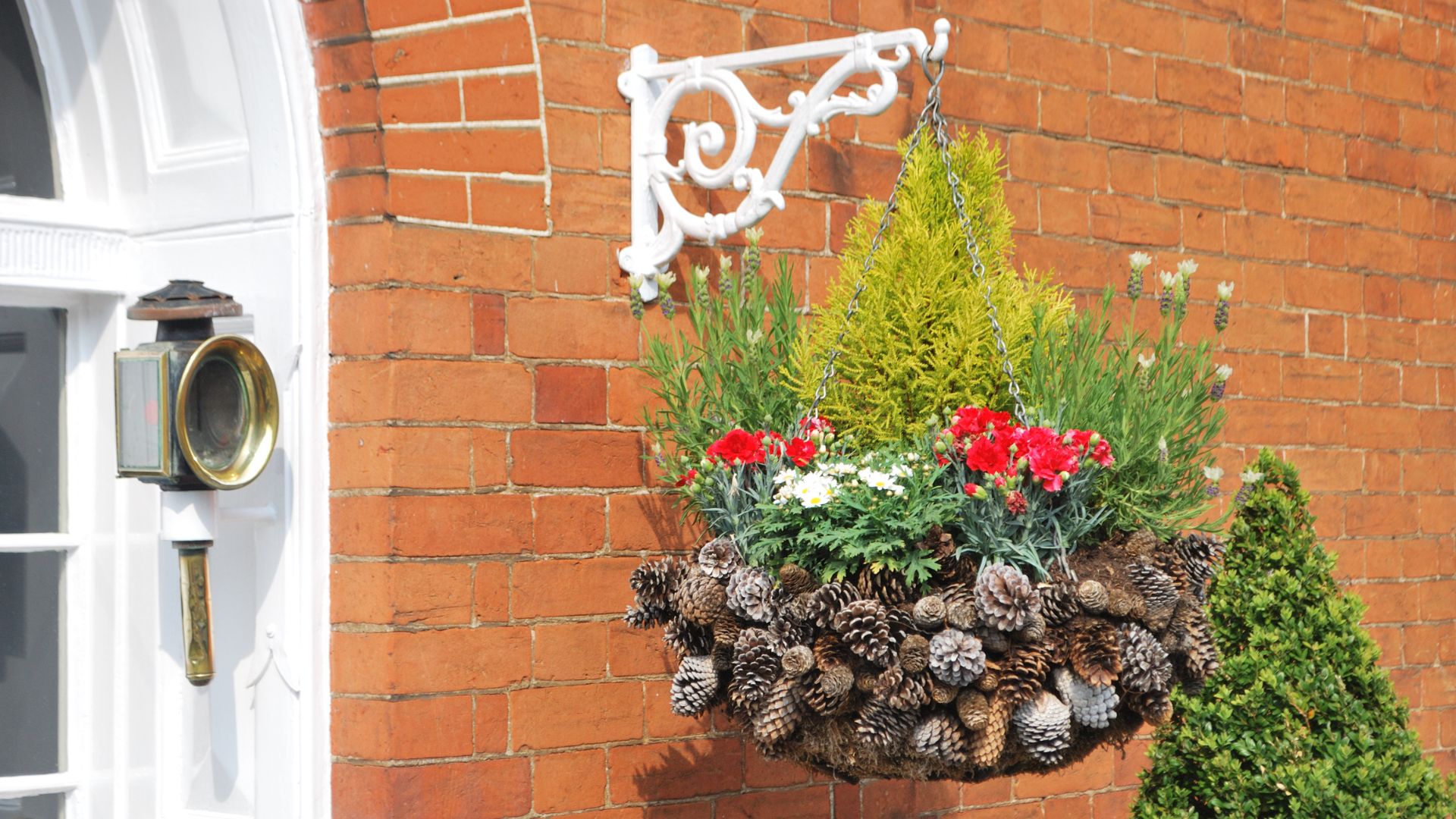picture of a winter hanging basket hanging outside front door of home
