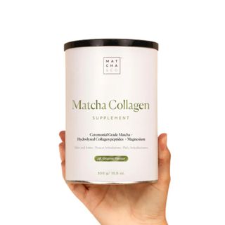 hand holding a tub of Matcha and co matcha green tea