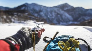 compass bubbles: mountaineer looking at map and compass