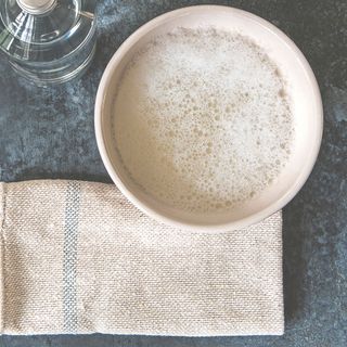 coffee mug with kitchen towel and bottle