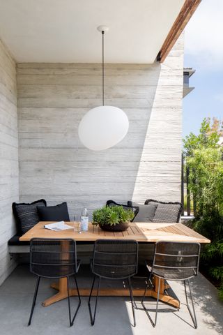Outdoor dining area with simple pendant light