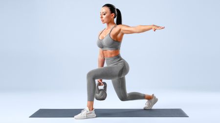 a woman doing a kettlebell lunge