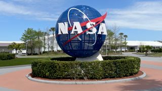 outdoor sculpture of nasa's spherical blue-and-white "meatball" logo