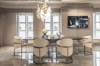 Visionnaire, London furniture shopping showroom in Chelsea Harbour, with muted colour palettes and a large marble dining table with chairs