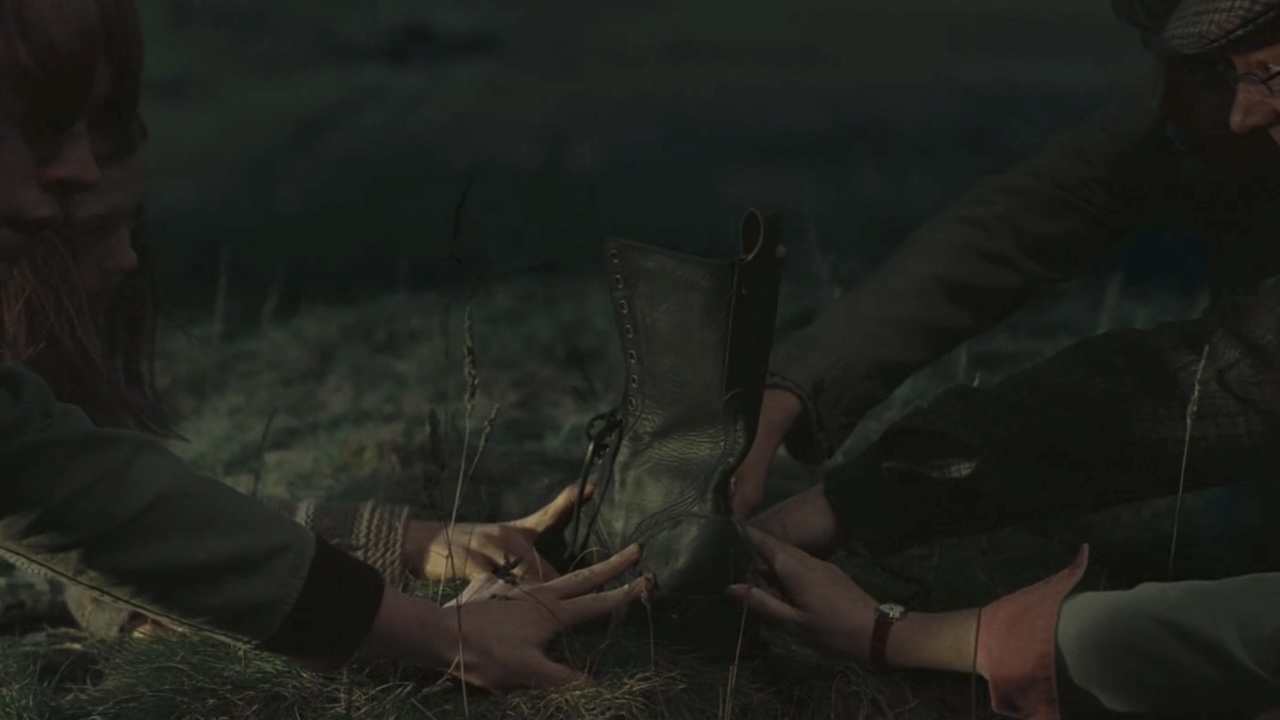 Hands touching an old boot that's a portkey in Harry Potter and the Goblet of Fire