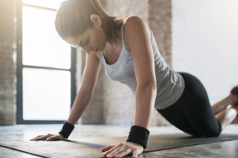 A woman doing kneeling press-ups