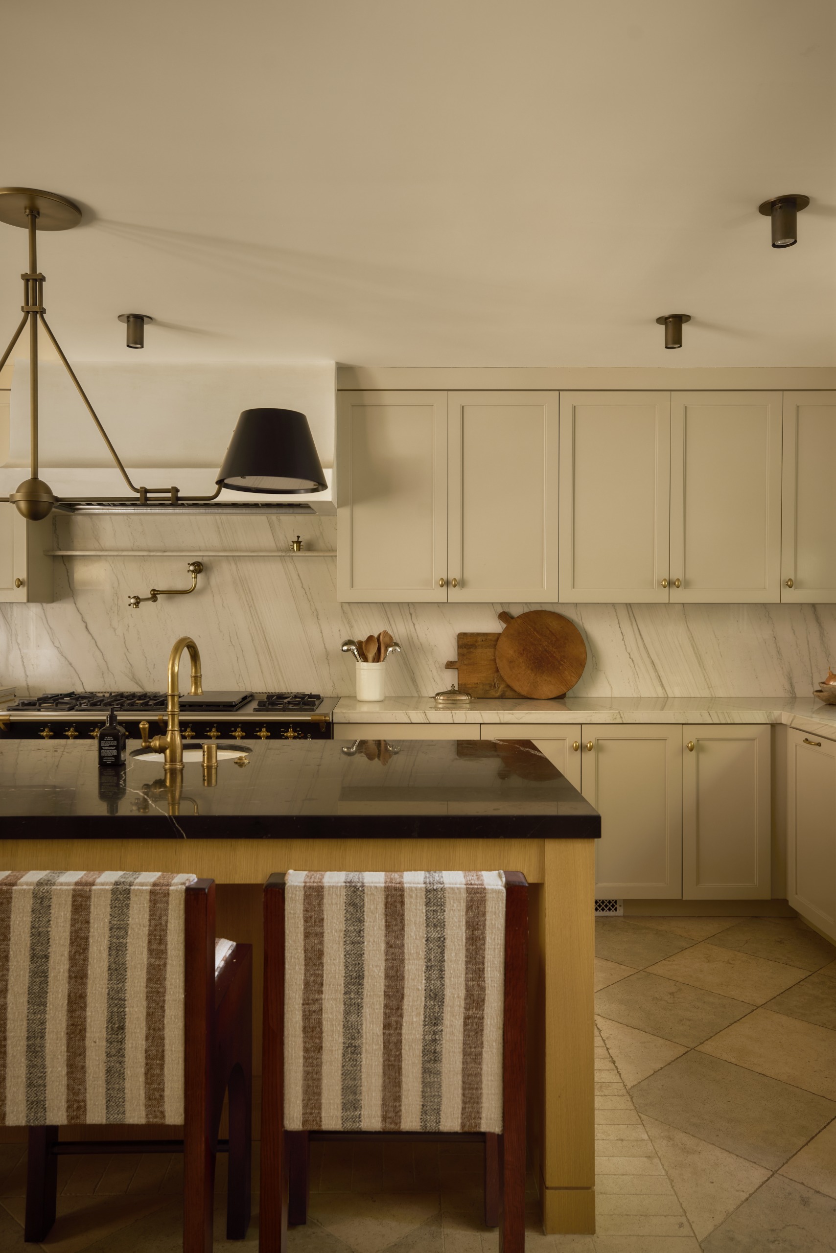 Beautiful open plan kitchen with large central island with black counters and a wooden base