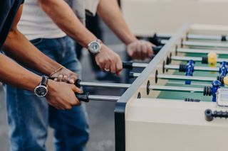 Two men playing table football.