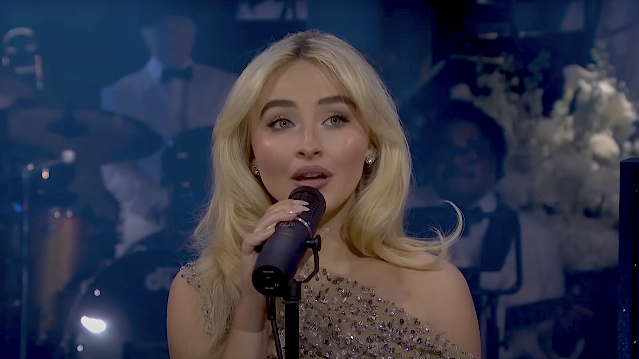 Sabrina Carpenter performing in sparkly dress at SNL 50.